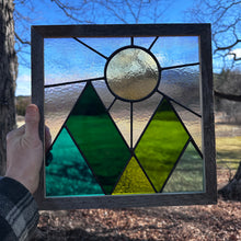 Framed mountains and sun
