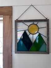 Framed mountains and sun