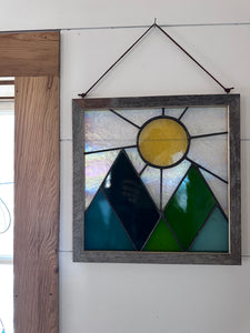Framed mountains and sun